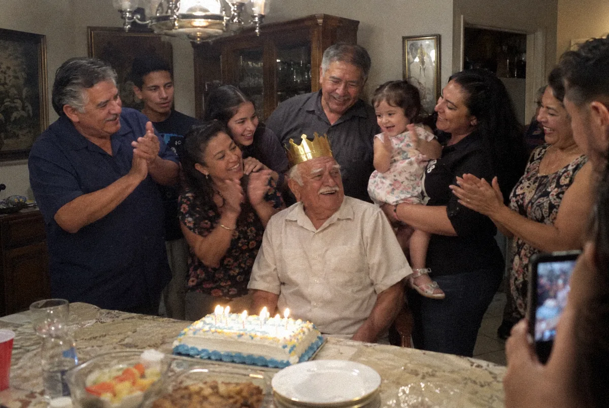 The Alvarez family around their grandfather at his eightieth birthday